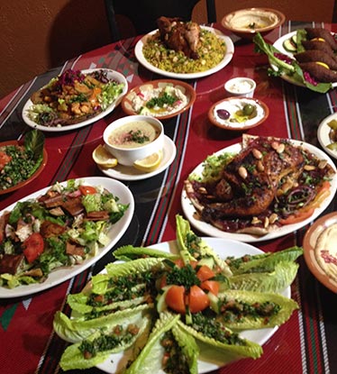 table full of Classic Red Hot Albasha dishes